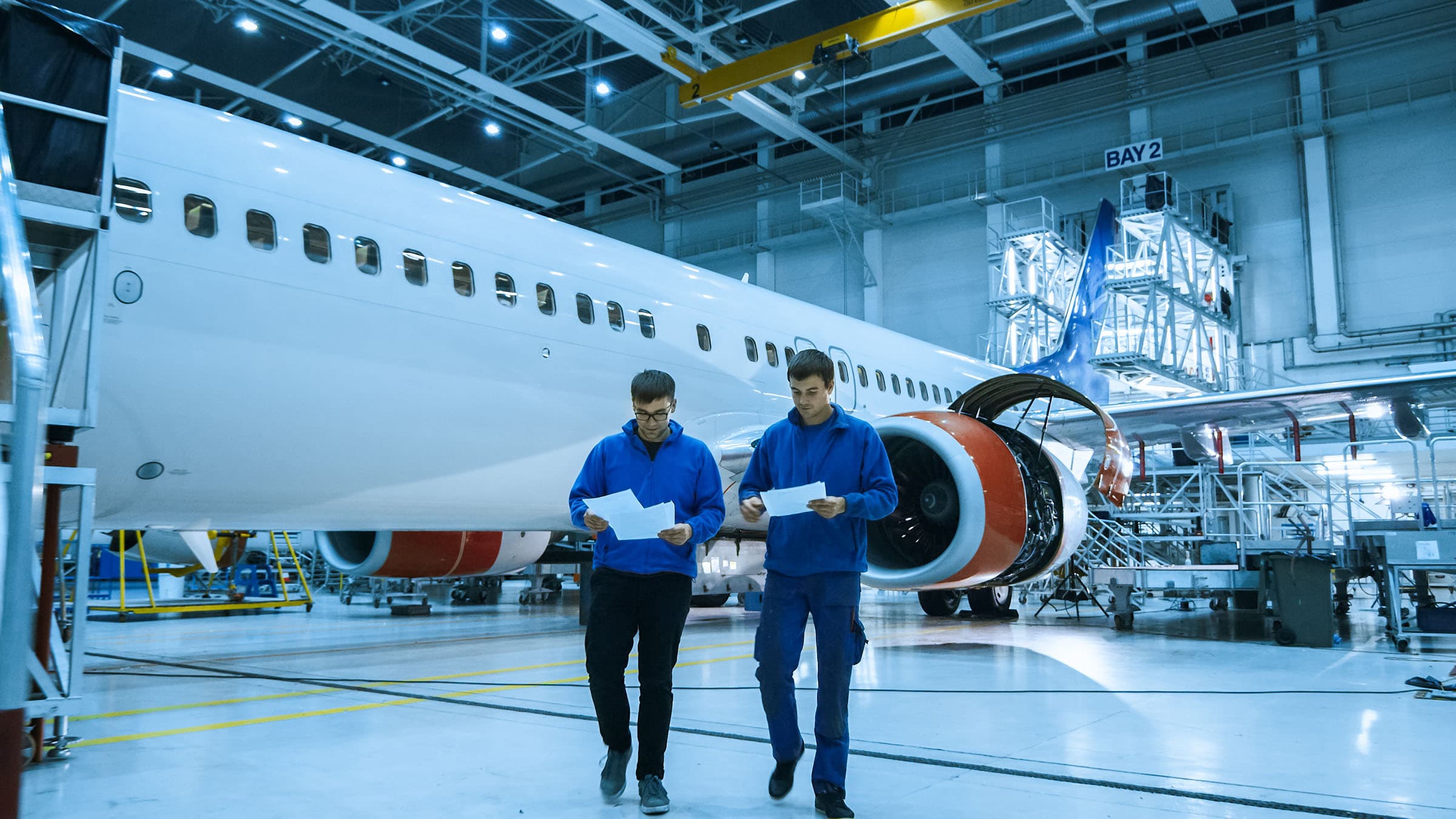 Aircraft in hangar with engineers